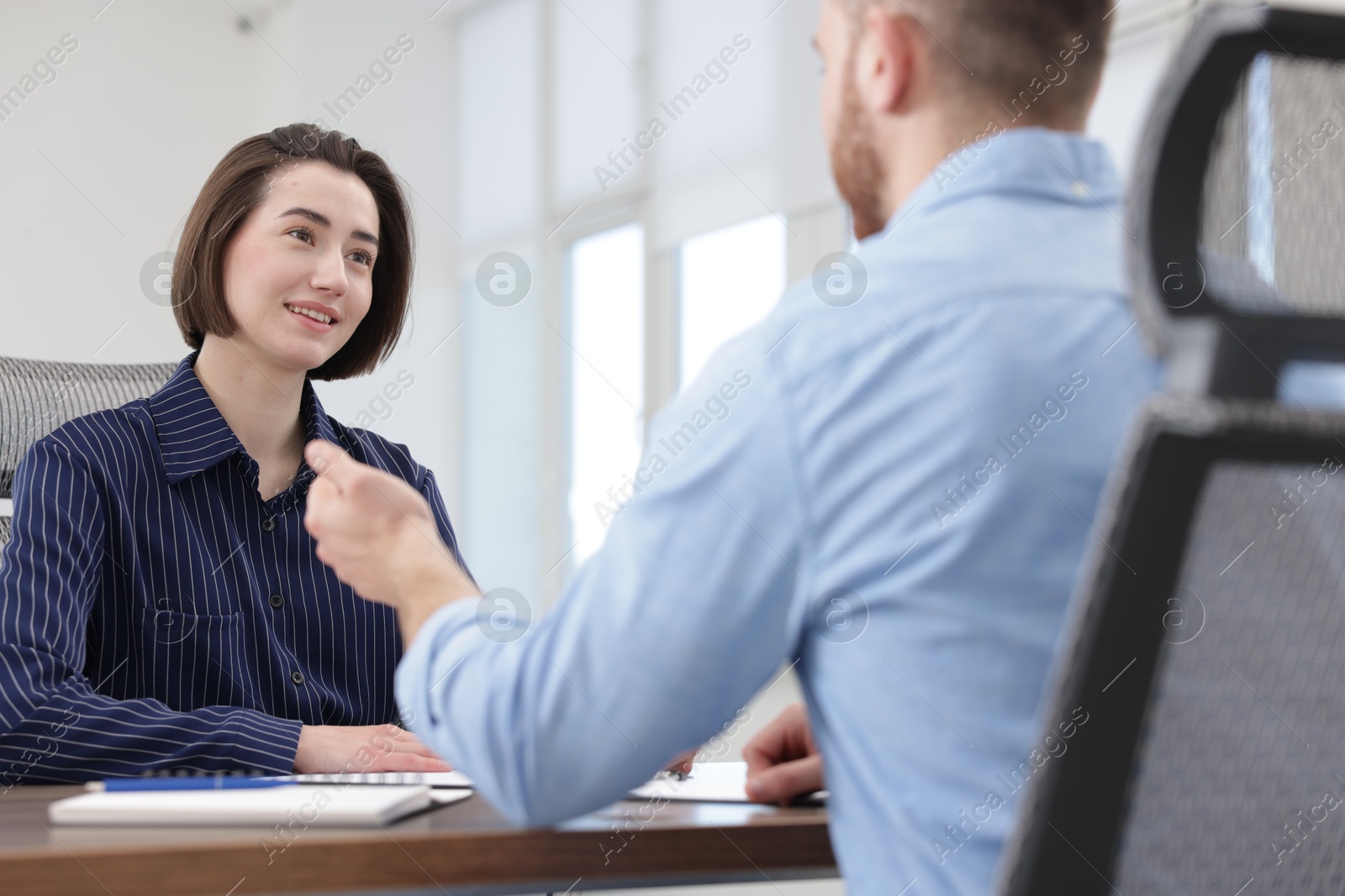 Recruiter and candidate having job interview at desk in office Photo of Recruiter and candidate having job interview at desk in office