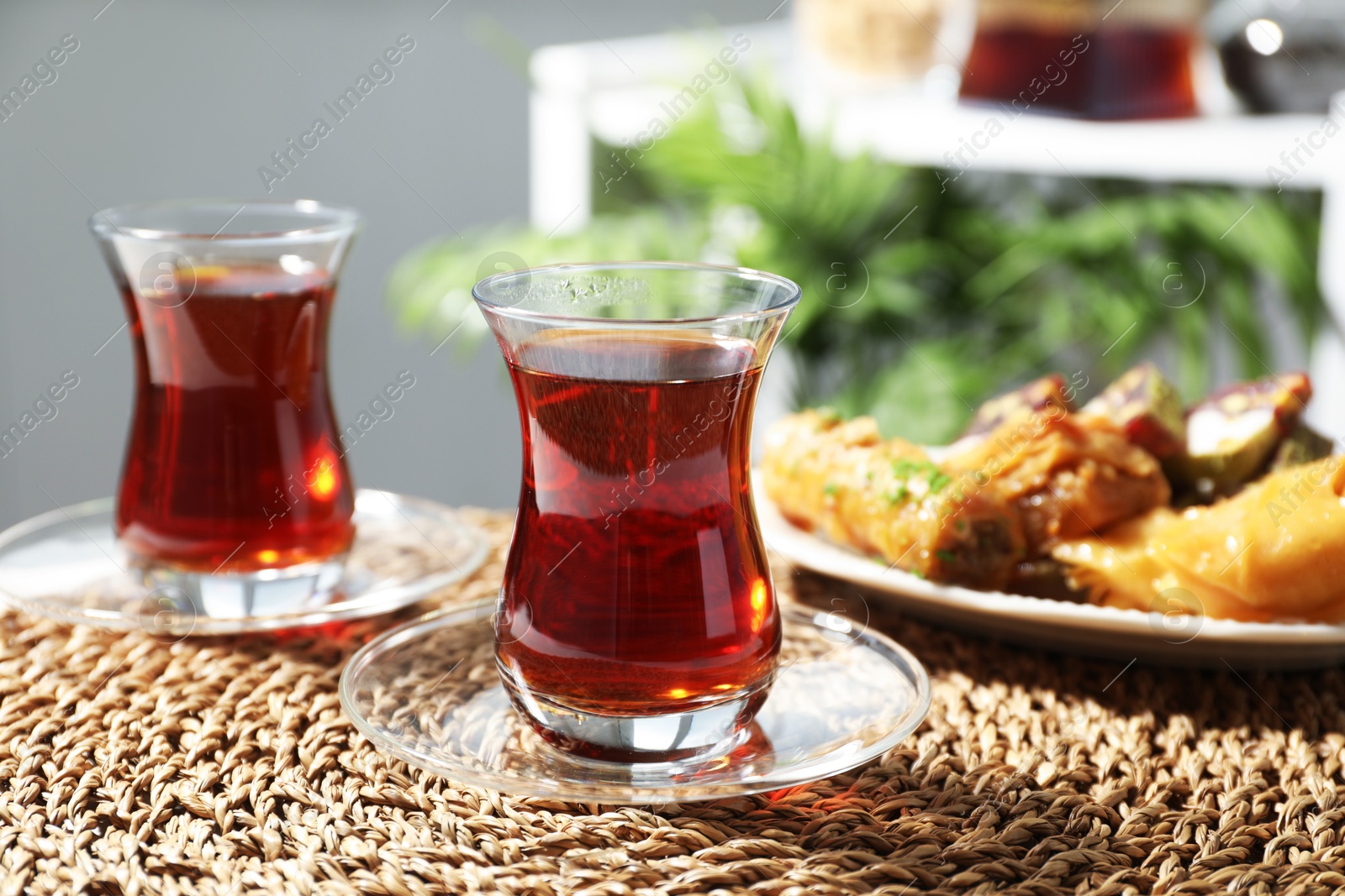 Traditional Turkish tea in glass cups and sweets on table, closeup Photo of Traditional Turkish tea in glass cups and sweets on table, closeup