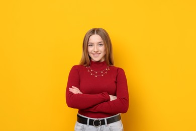 Photo of Portrait of smiling teenage girl on yellow background