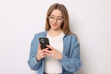 Photo of Beautiful teenage girl with smartphone on white background