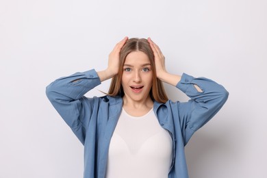 Photo of Portrait of emotional teenage girl on white background
