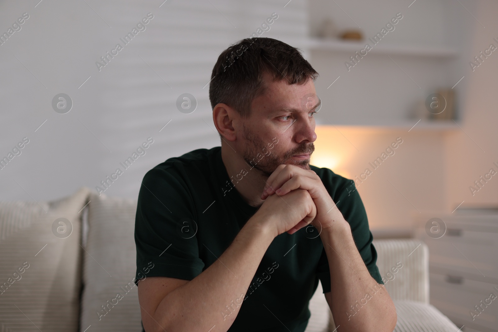 Depressed man on sofa at home. Mental health problem Photo of Depressed man on sofa at home. Mental health problem