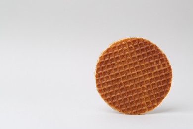 Photo of One tasty round waffle on white background. Space for text