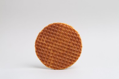 Photo of One tasty round waffle on white background
