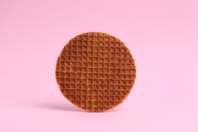 Photo of One tasty round waffle on pink background