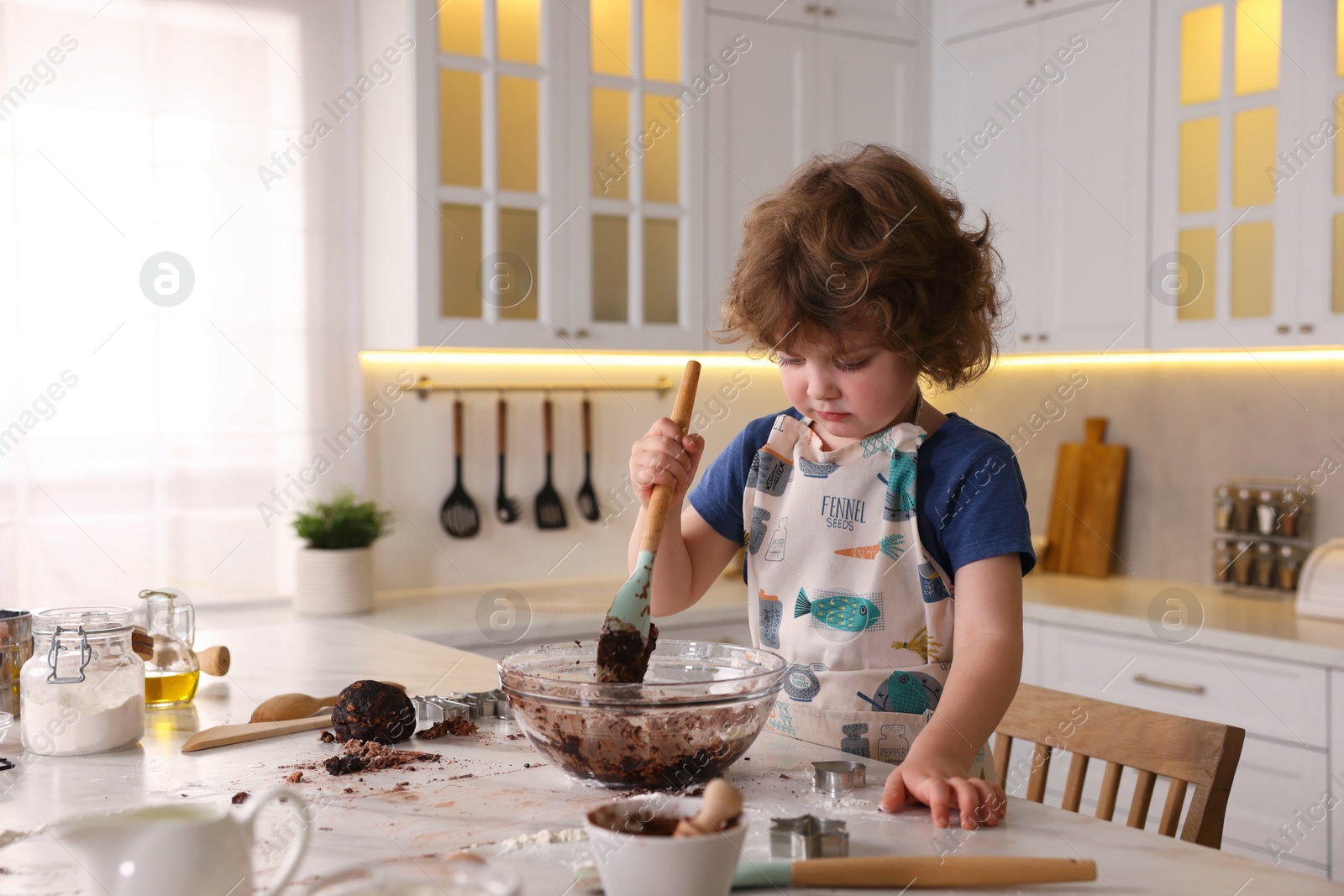 Cooking recipe. Little boy making dough for cookies at table in kitchen Photo of Cooking recipe. Little boy making dough for cookies at table in kitchen