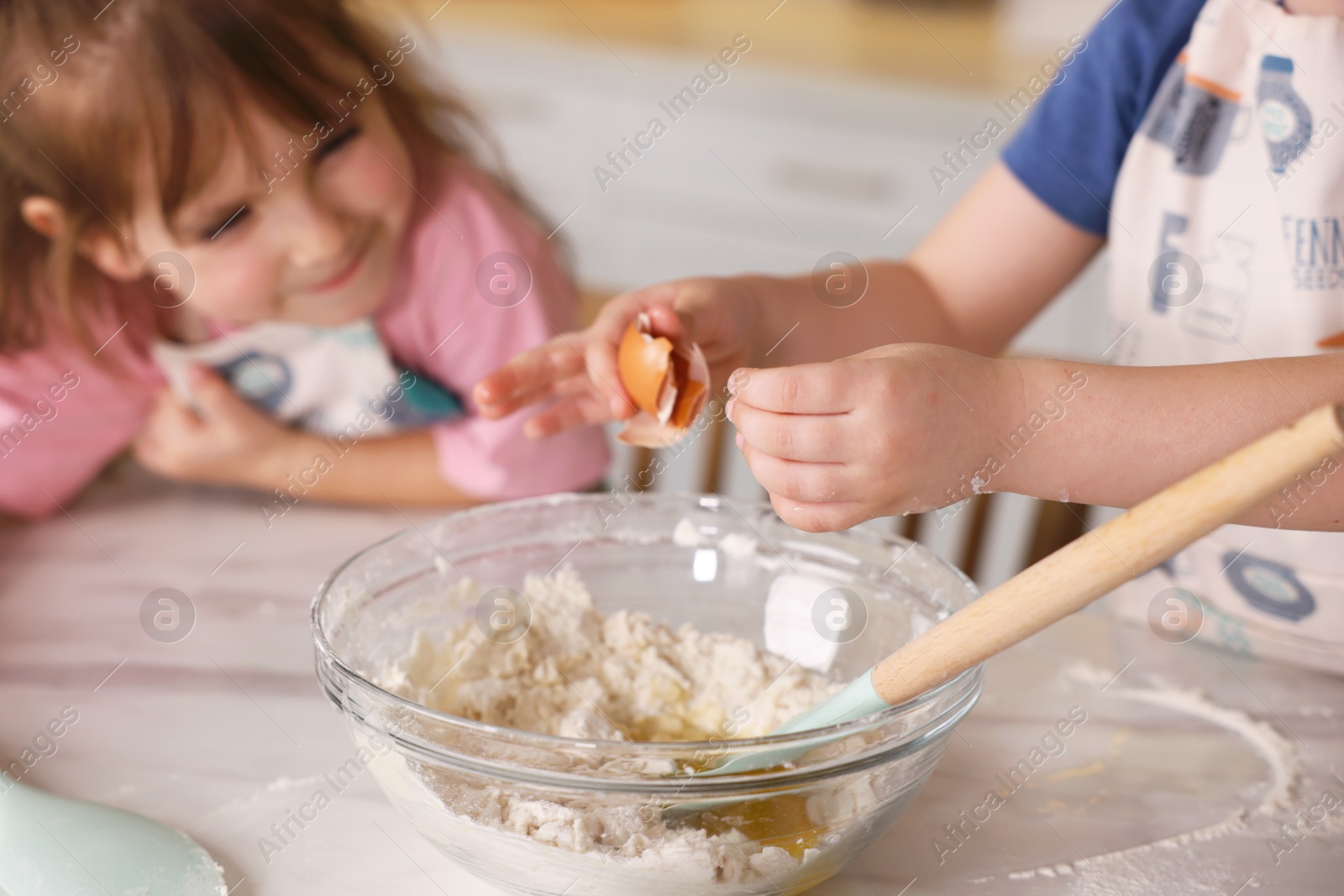 Cooking recipe. Cute children making dough for cookies at table in kitchen, closeup Photo of Cooking recipe. Cute children making dough for cookies at table in kitchen, closeup