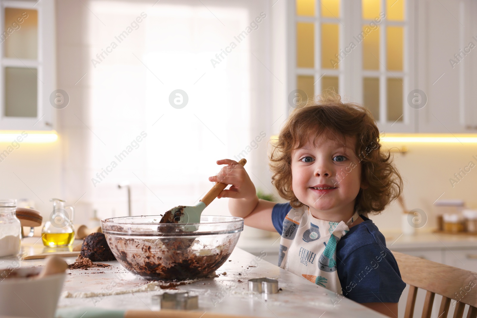 Cooking recipe. Little boy making dough for cookies at table in kitchen. Space for text Photo of Cooking recipe. Little boy making dough for cookies at table in kitchen. Space for text