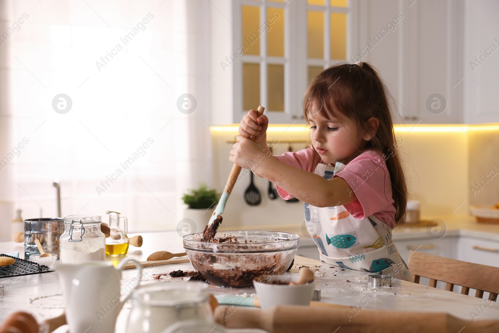 Cooking recipe. Little girl making dough for cookies at table in kitchen. Space for text Photo of Cooking recipe. Little girl making dough for cookies at table in kitchen. Space for text
