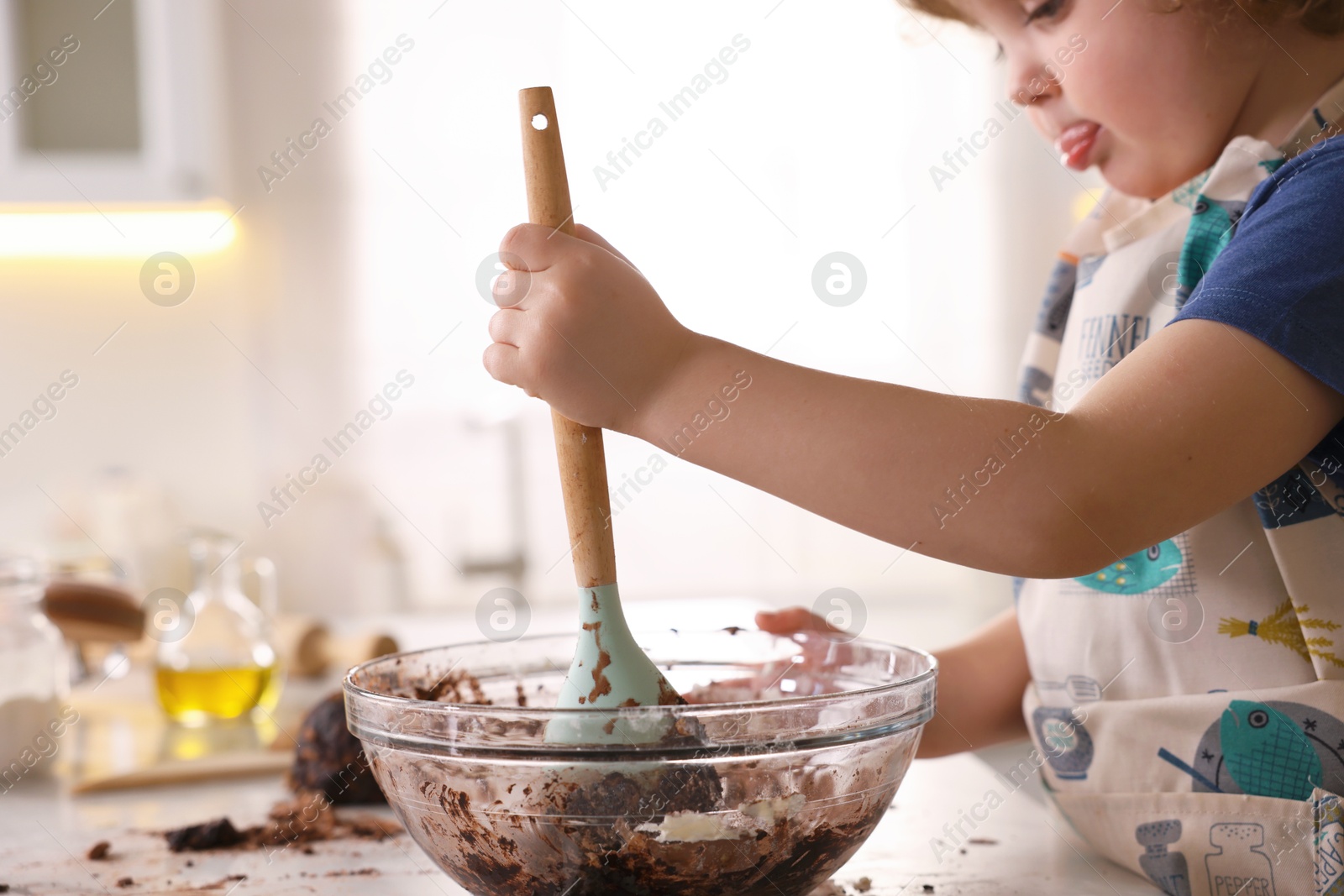 Cooking recipe. Little boy making dough for cookies at table in kitchen, closeup Photo of Cooking recipe. Little boy making dough for cookies at table in kitchen, closeup