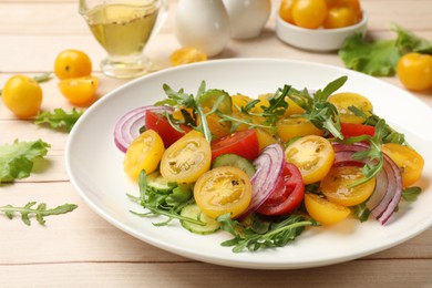 Photo of Fresh salad with yellow tomatoes on white wooden table, closeup