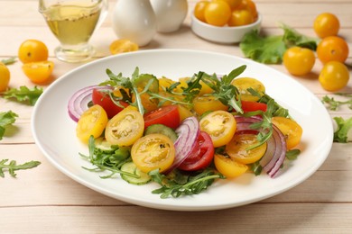 Photo of Fresh salad with yellow tomatoes on white wooden table, closeup