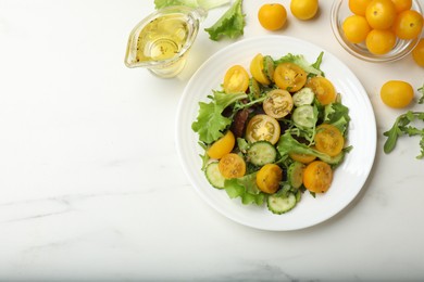 Photo of Fresh salad with yellow tomatoes on white table, flat lay. Space for text