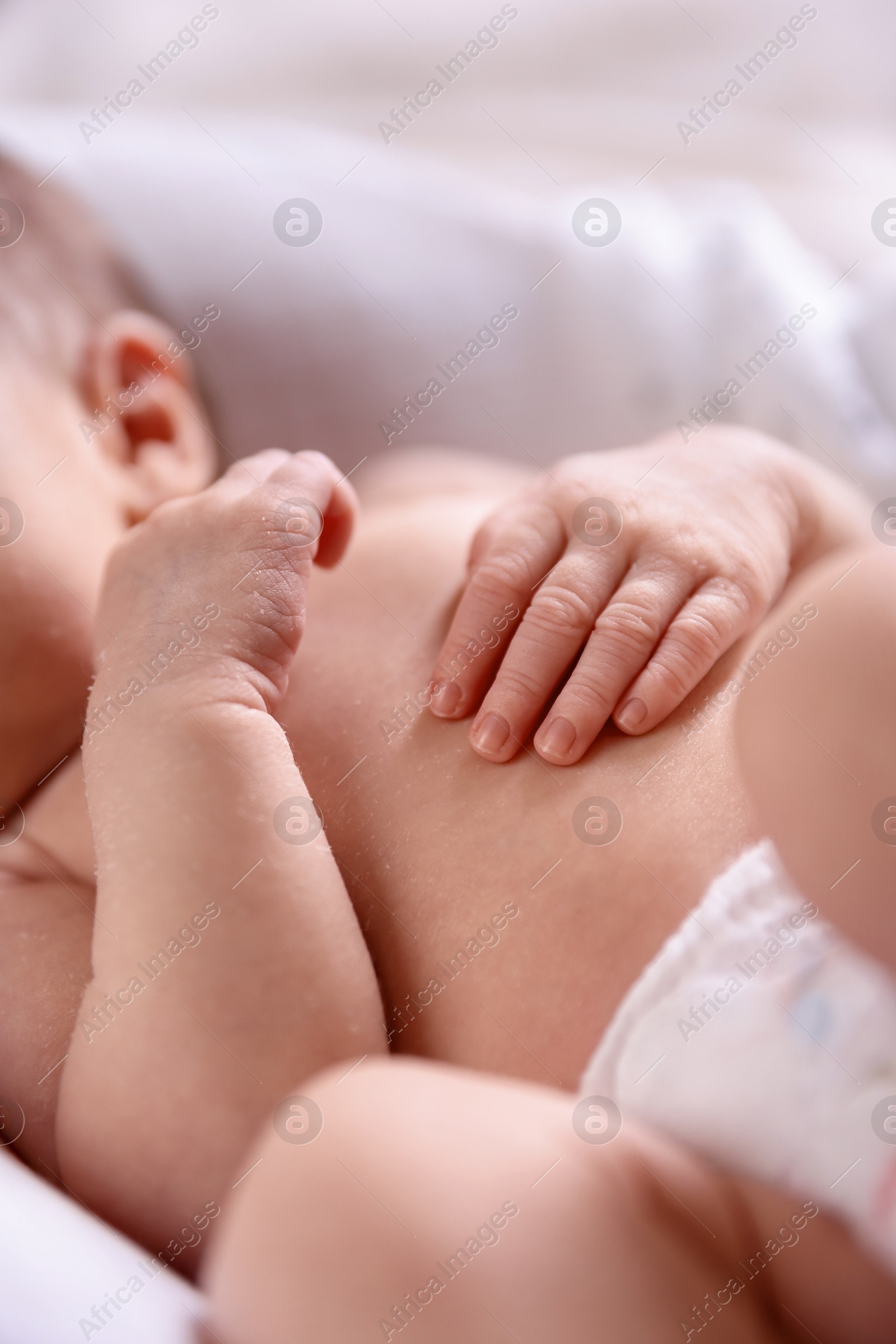 Little baby lying on bed indoors, closeup Photo of Little baby lying on bed indoors, closeup