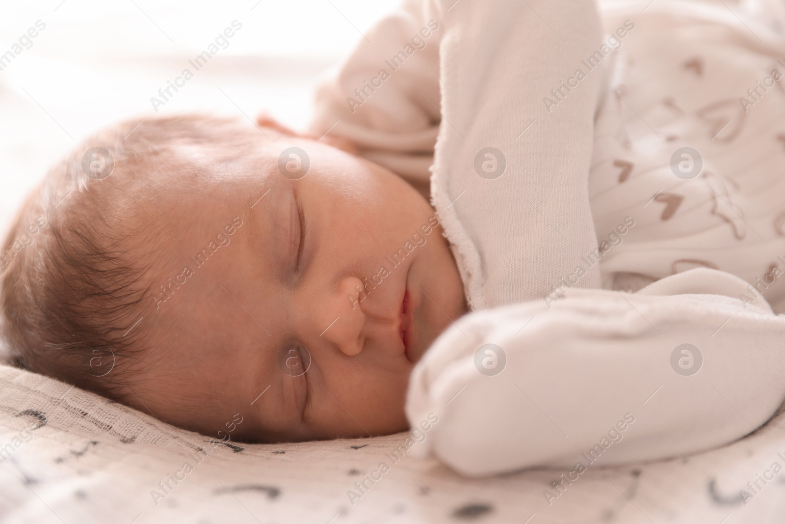 Bedtime. Cute little baby sleeping in bed indoors Photo of Bedtime. Cute little baby sleeping in bed indoors