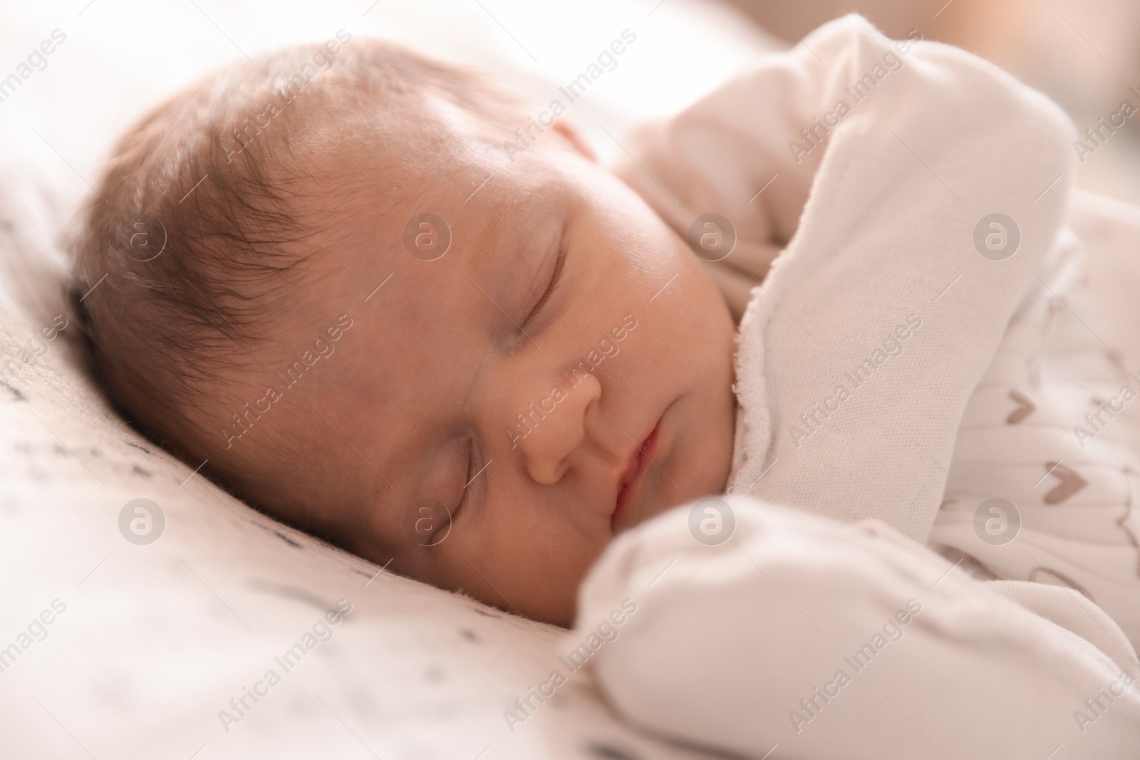 Bedtime. Cute little baby sleeping in bed indoors Photo of Bedtime. Cute little baby sleeping in bed indoors