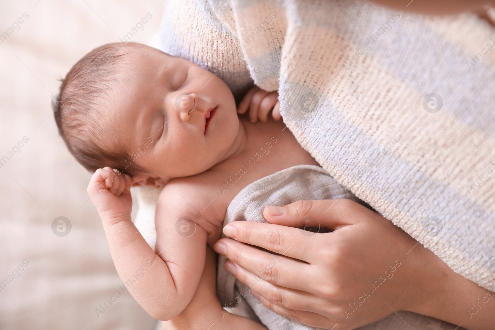 Bedtime. Mother with her sleeping baby indoors, closeup Photo of Bedtime. Mother with her sleeping baby indoors, closeup