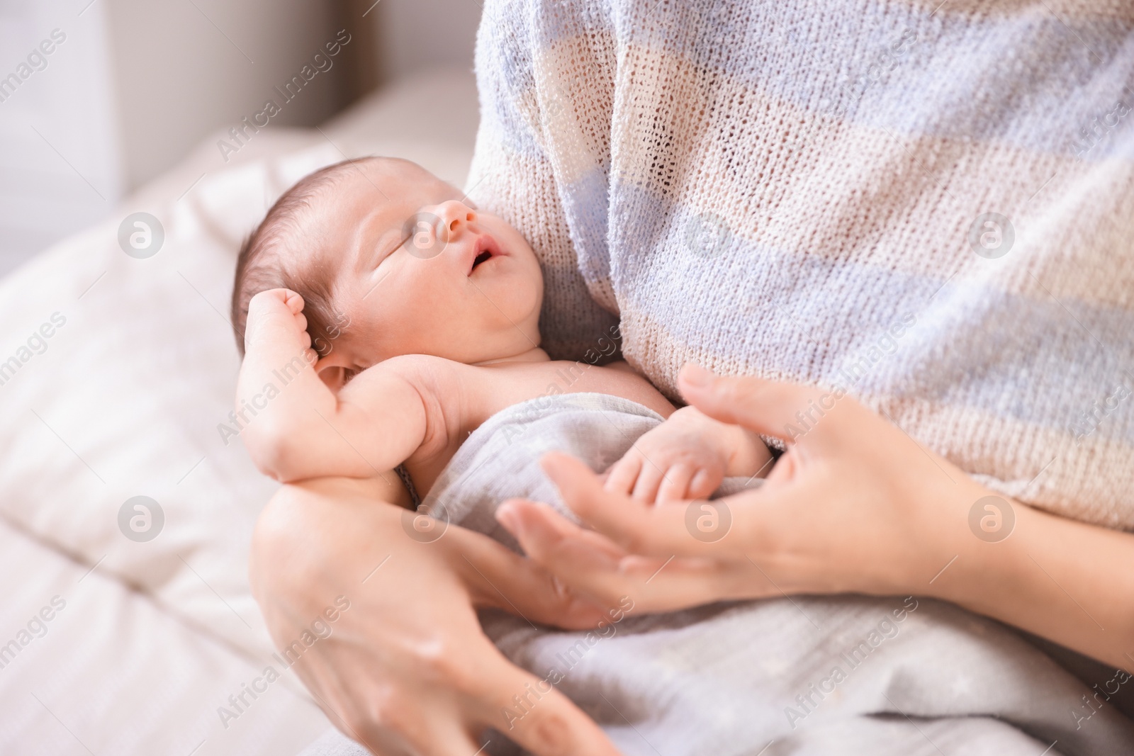 Bedtime. Mother with her sleeping baby indoors, closeup Photo of Bedtime. Mother with her sleeping baby indoors, closeup