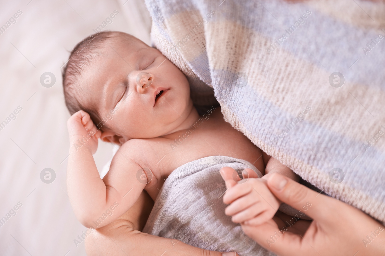 Bedtime. Mother with her sleeping baby indoors, closeup Photo of Bedtime. Mother with her sleeping baby indoors, closeup