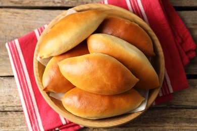 Photo of Tasty baked patties on wooden table, top view