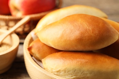 Photo of Tasty baked patties on wooden table, closeup