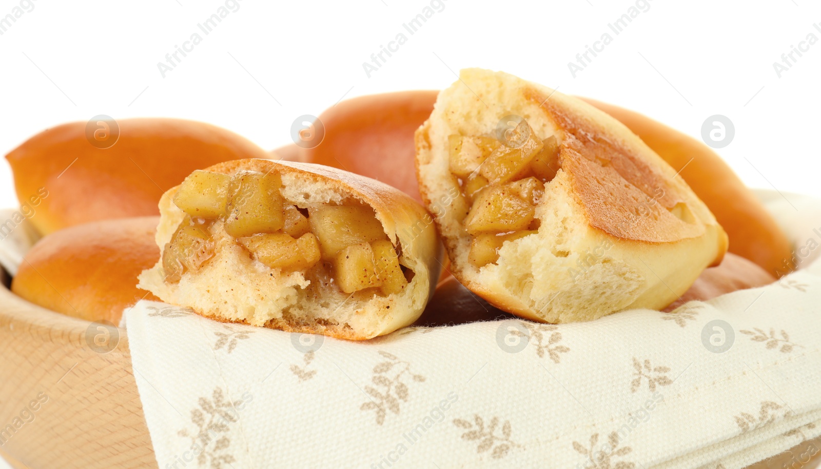 Tasty baked patties with apples in wooden bowl isolated on white Photo of Tasty baked patties with apples in wooden bowl isolated on white