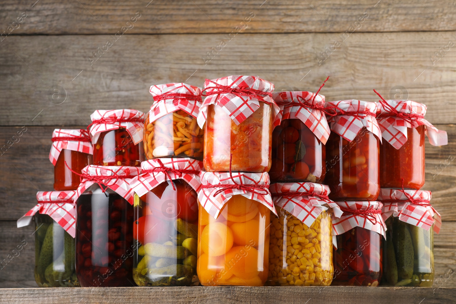 Many jars with different pickled products on wooden table Photo of Many jars with different pickled products on wooden table