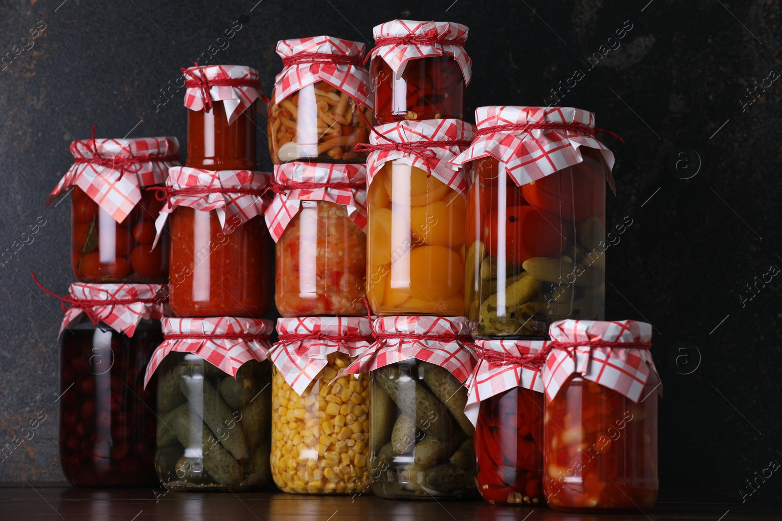 Many jars with different pickled products on wooden table Photo of Many jars with different pickled products on wooden table