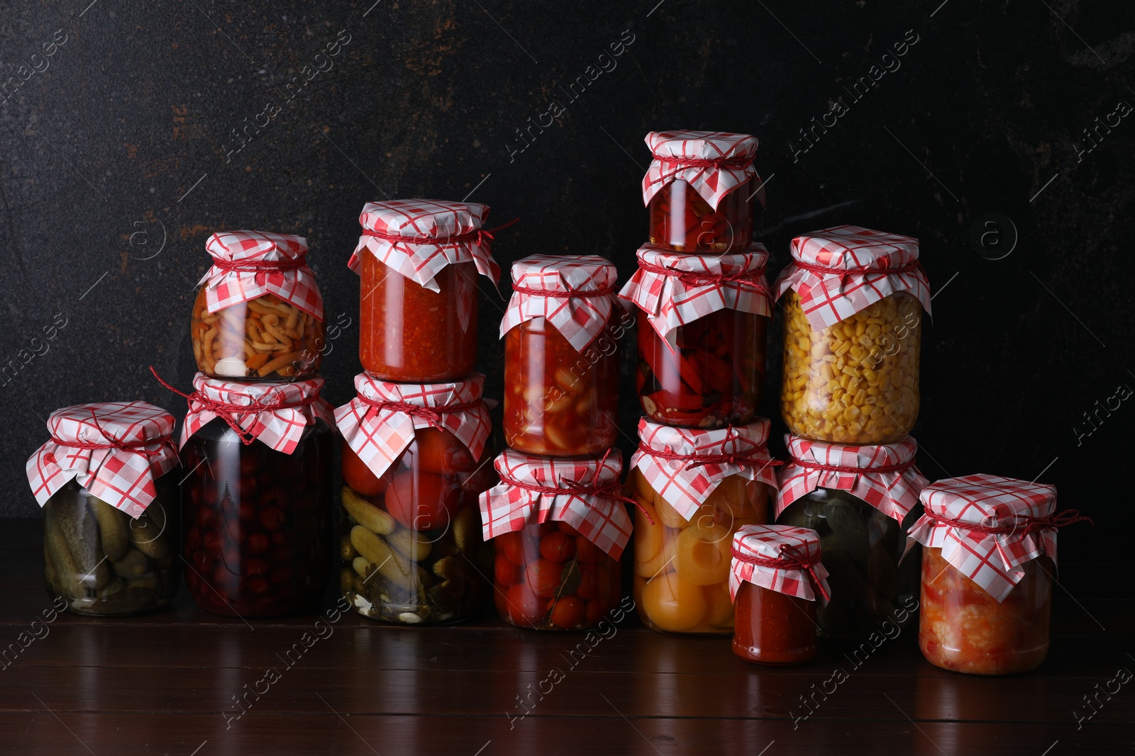 Many jars with different pickled products on wooden table Photo of Many jars with different pickled products on wooden table