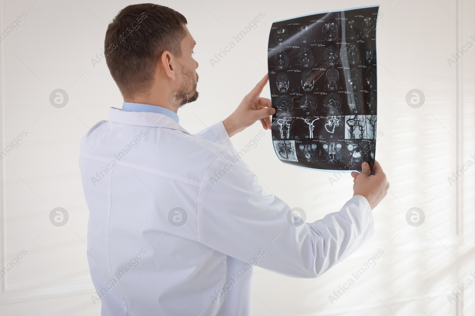 Doctor examining brain MRI scan in clinic Photo of Doctor examining brain MRI scan in clinic