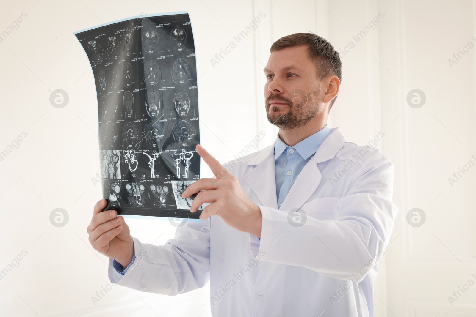 Doctor examining brain MRI scan in clinic Photo of Doctor examining brain MRI scan in clinic