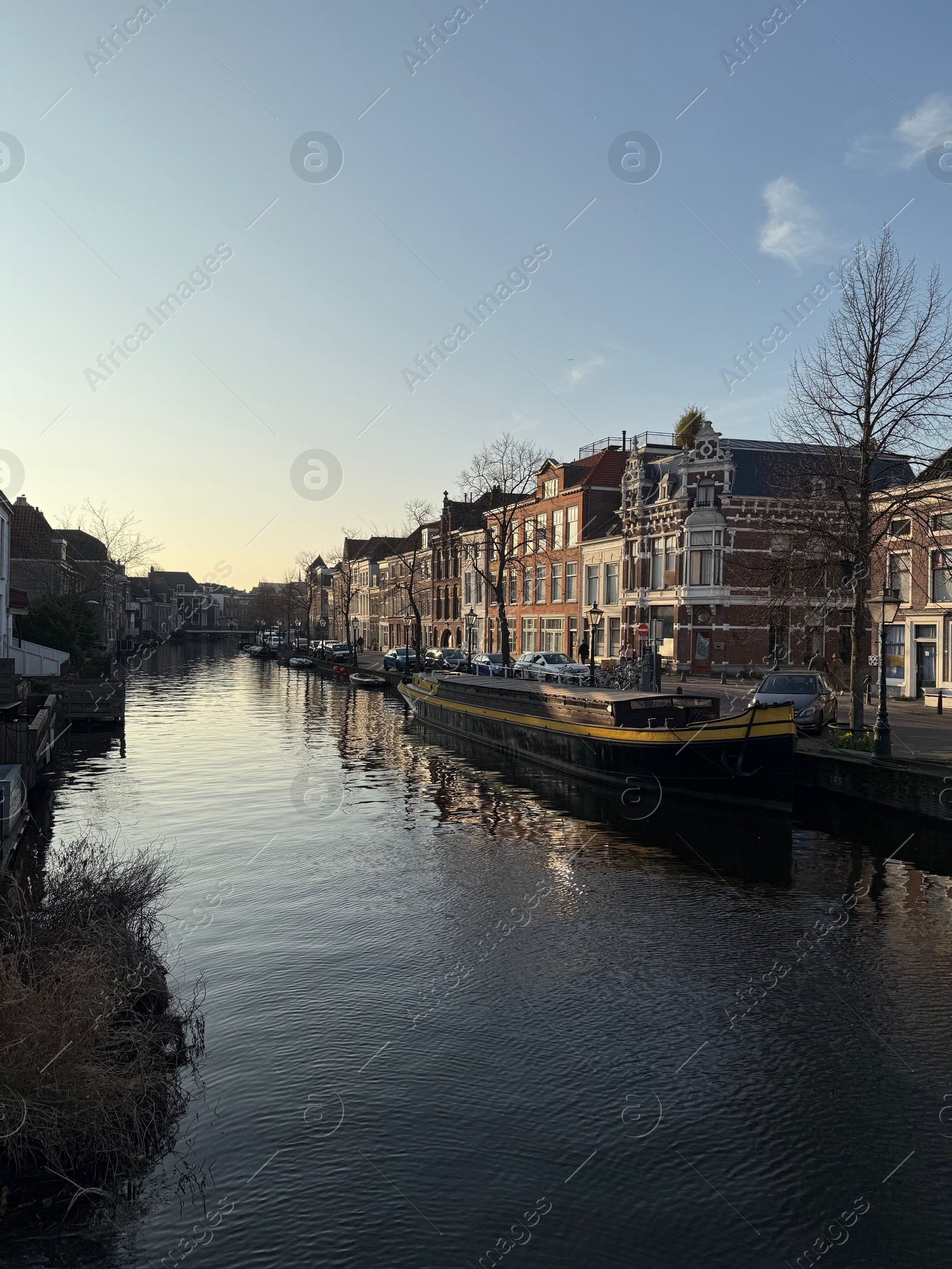 Leiden, Netherlands - March 9, 2025: Picturesque view of canal with moored boats in city Photo of Leiden, Netherlands - March 9, 2025: Picturesque view of canal with moored boats in city