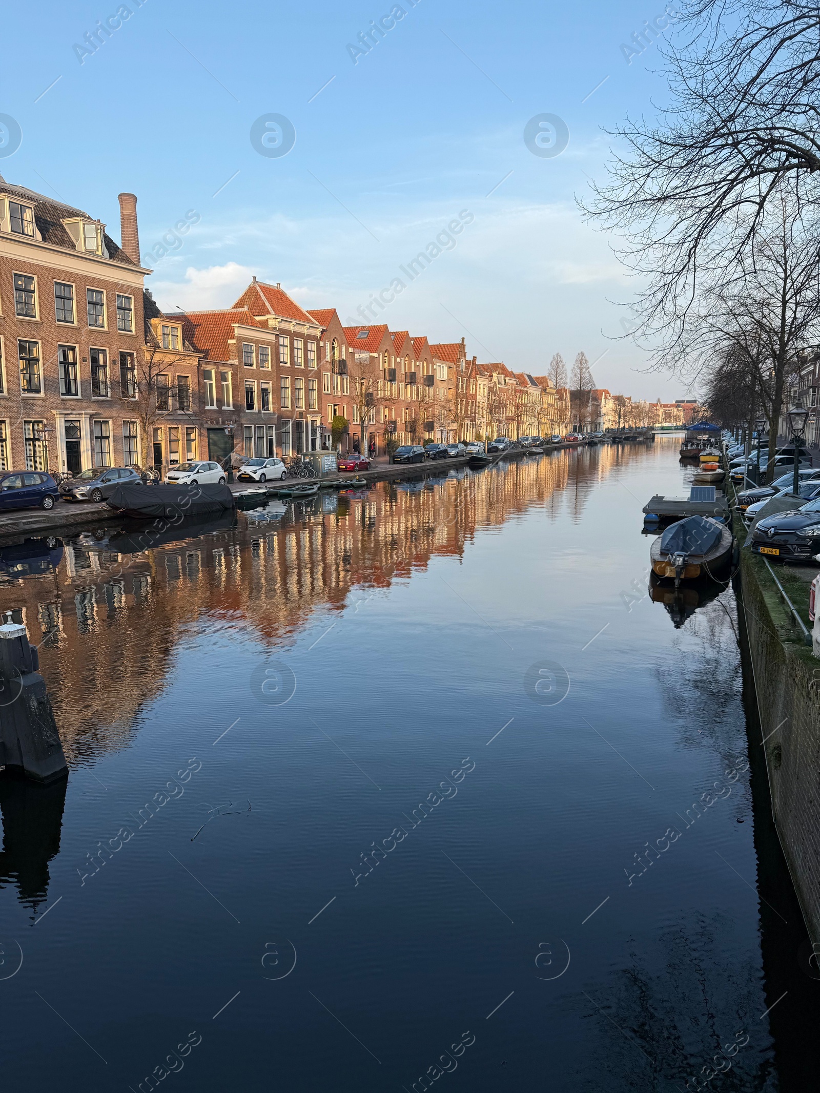 Leiden, Netherlands - March 9, 2025: Picturesque view of canal with moored boats in city Photo of Leiden, Netherlands - March 9, 2025: Picturesque view of canal with moored boats in city