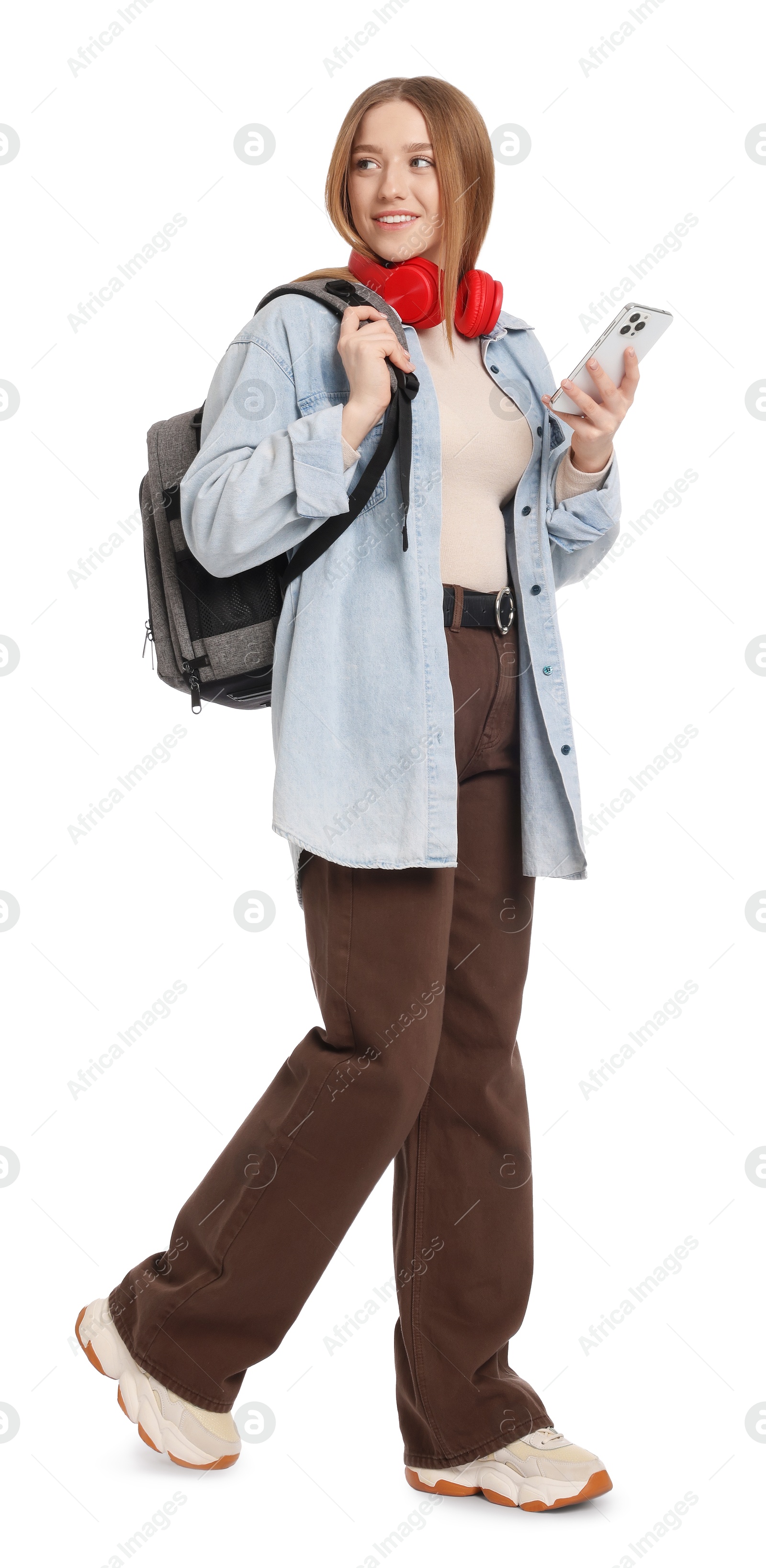 Smiling teenage girl with smartphone on white background Photo of Smiling teenage girl with smartphone on white background