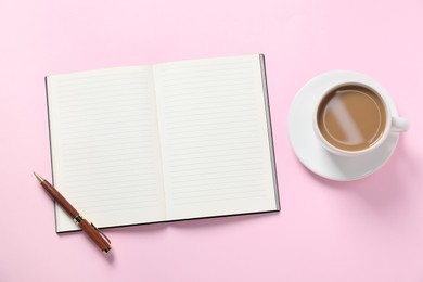 Photo of Open blank notebook, pen and coffee on pink background, flat lay