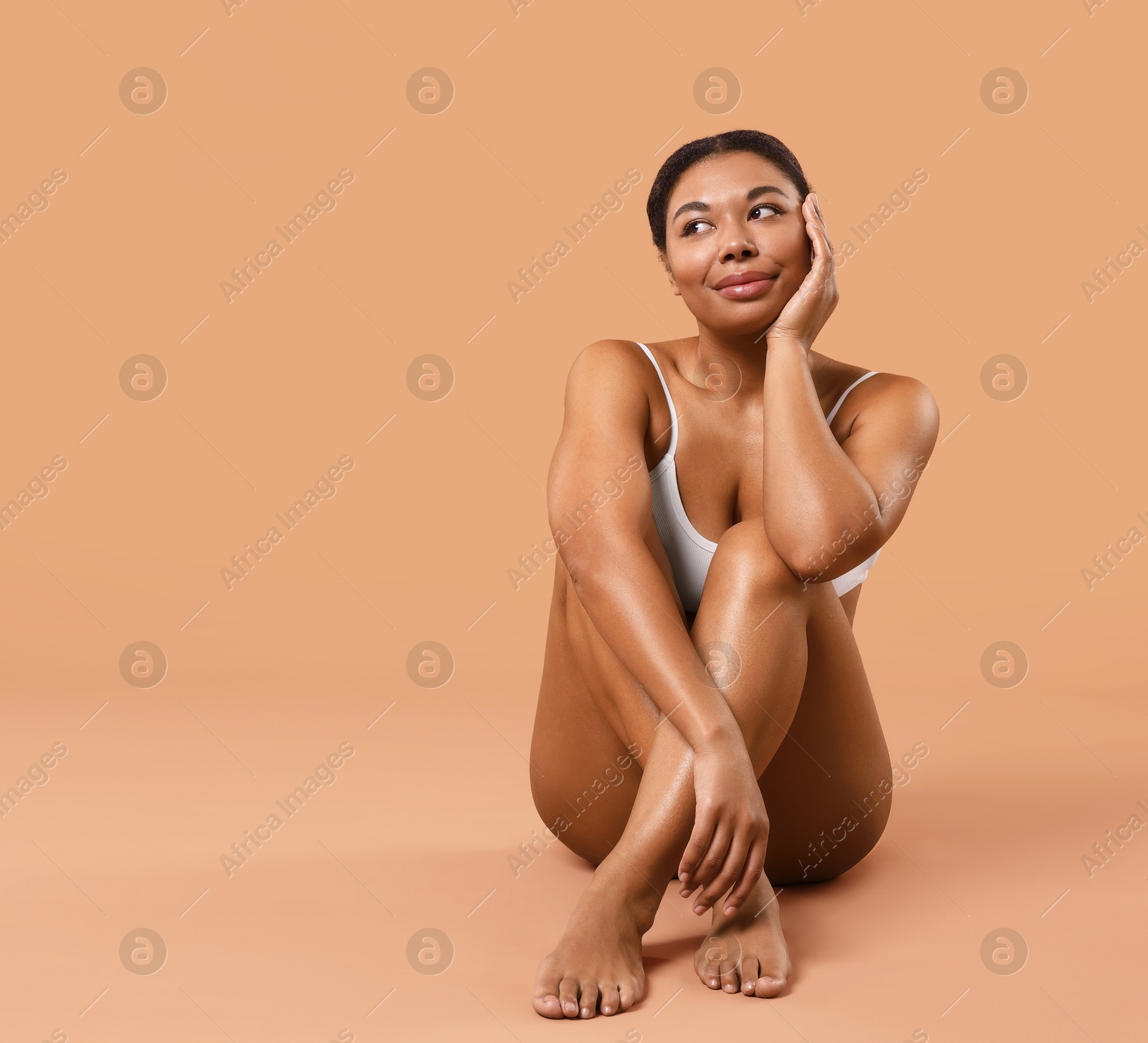 Woman in underwear with smooth skin after epilation procedure on beige background, space for text Photo of Woman in underwear with smooth skin after epilation procedure on beige background, space for text