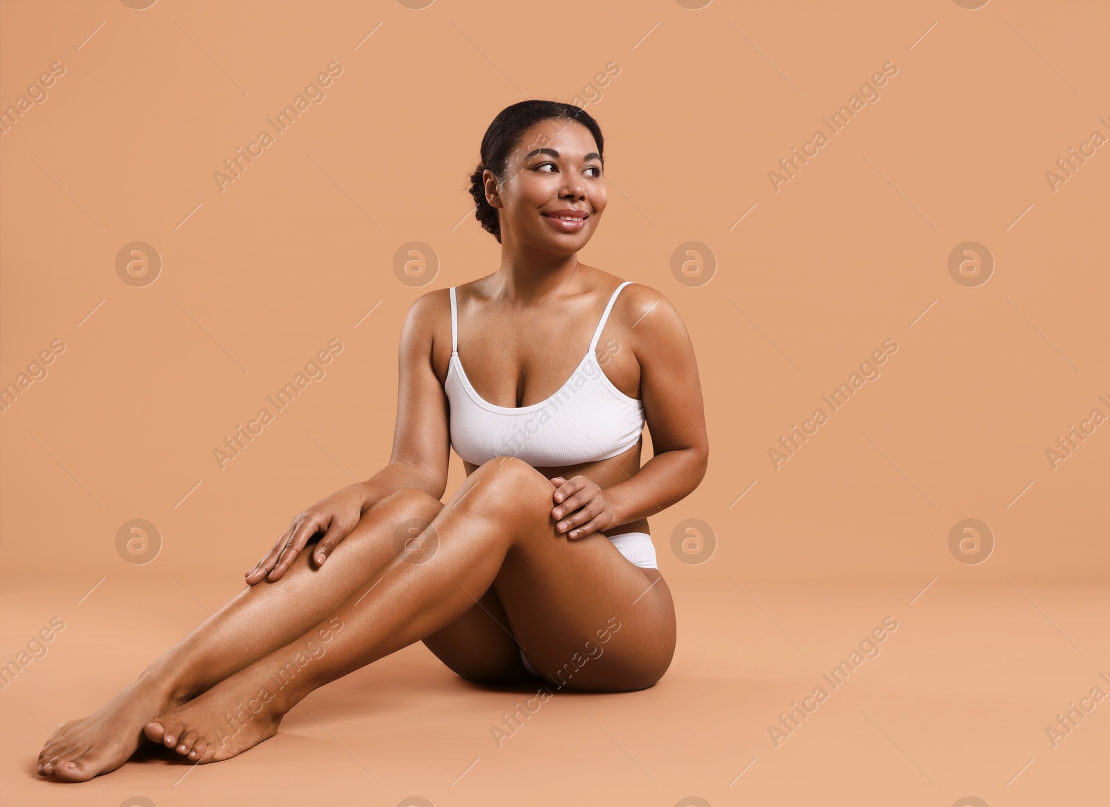 Woman in underwear with smooth skin after epilation procedure on beige background, space for text Photo of Woman in underwear with smooth skin after epilation procedure on beige background, space for text