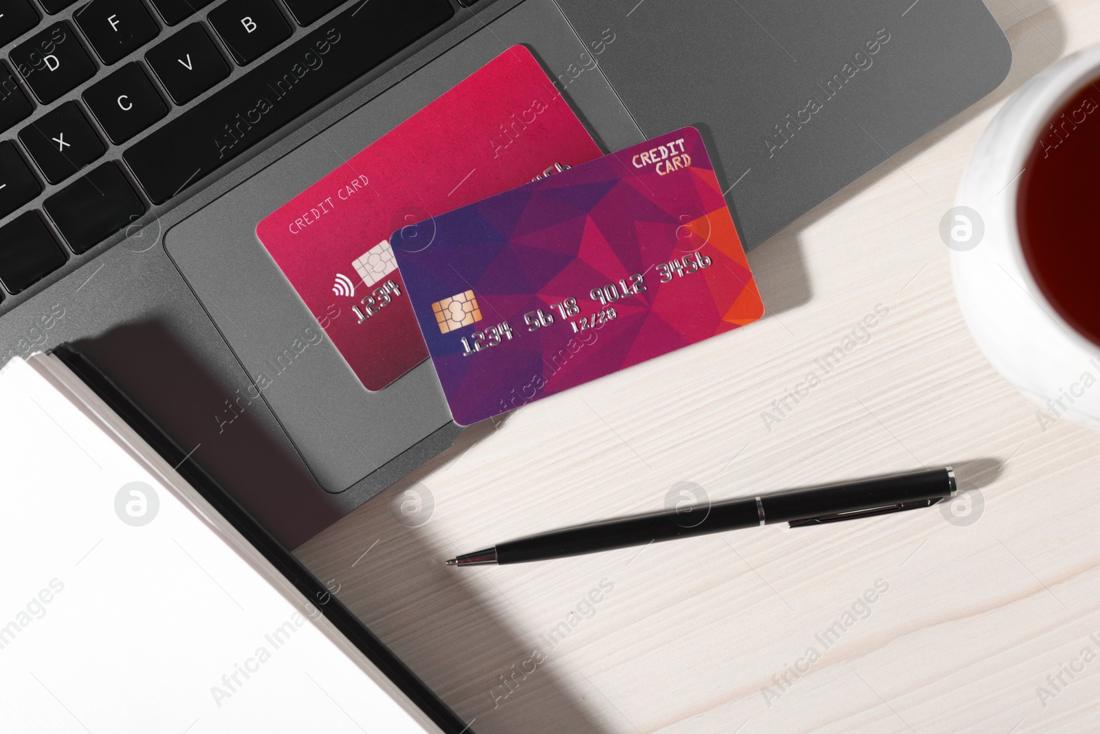 Online payment. Credit cards, pen and laptop on light wooden table, flat lay Photo of Online payment. Credit cards, pen and laptop on light wooden table, flat lay