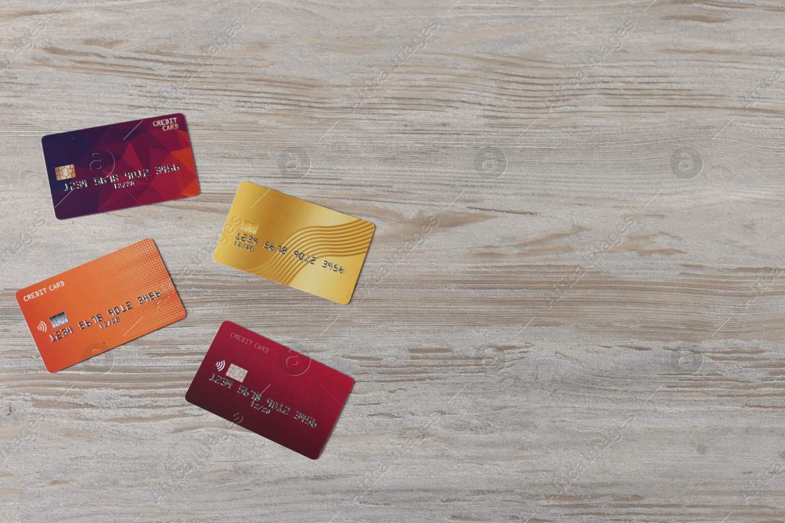 Photo of Online payment. Credit cards on grey wooden table, flat lay. Space for text