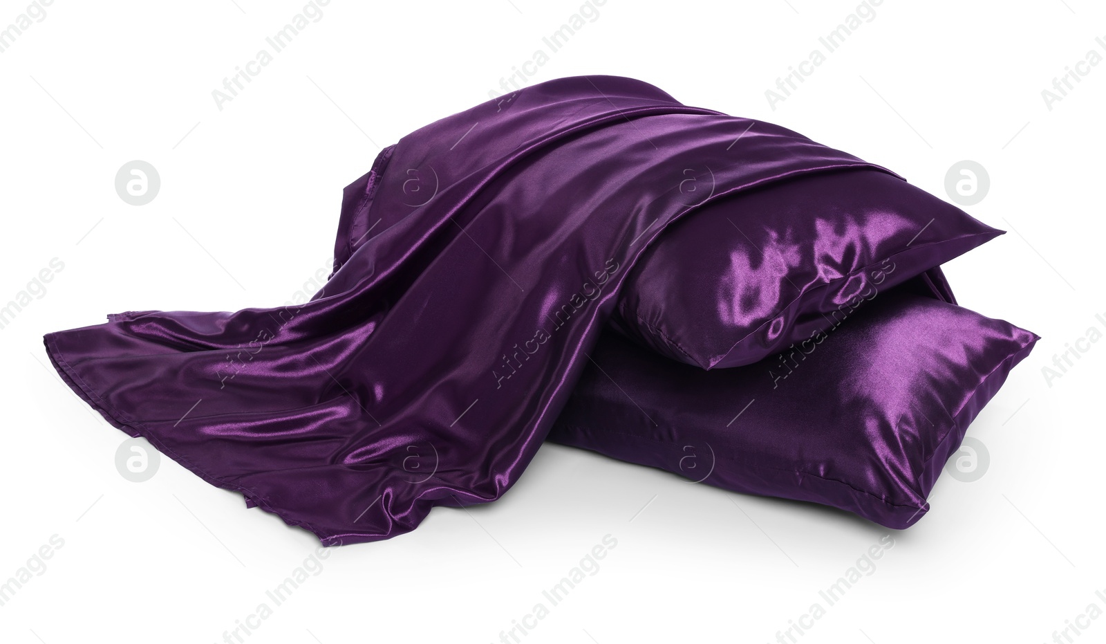 Pillows and silk bed linens isolated on white Photo of Pillows and silk bed linens isolated on white
