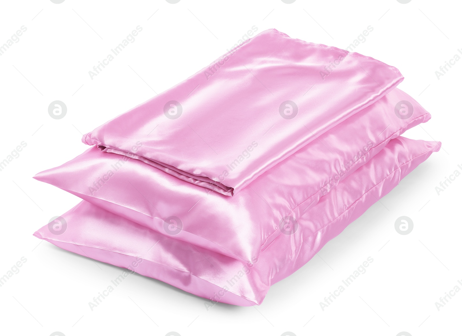 Pillows and silk bed linens isolated on white Photo of Pillows and silk bed linens isolated on white
