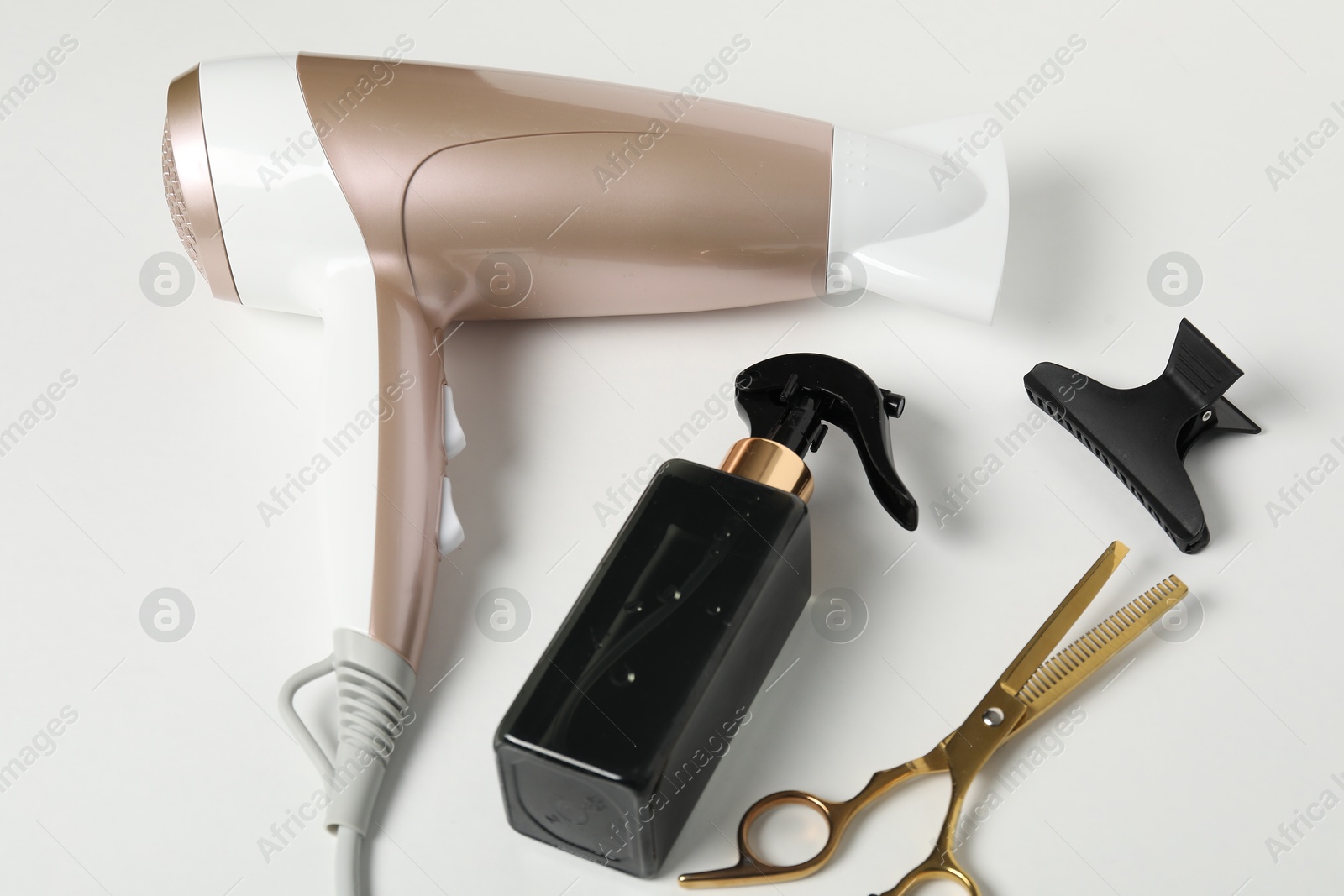Different hairstyling tools on white background, closeup Photo of Different hairstyling tools on white background, closeup