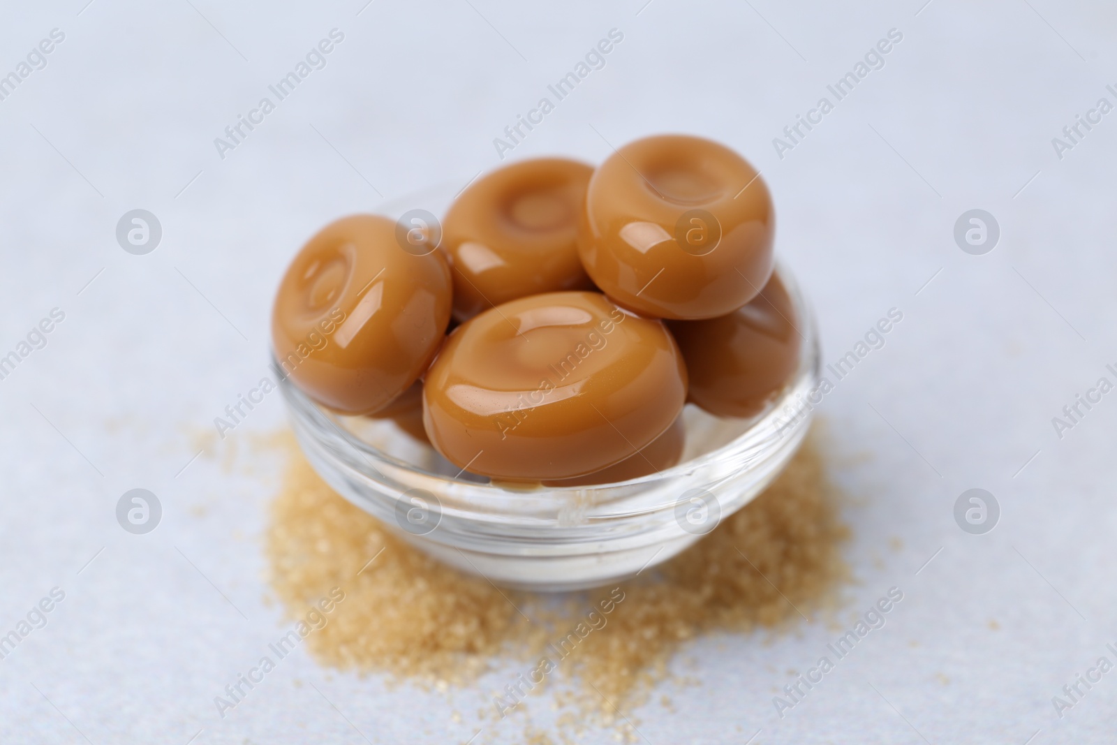 Tasty sweet caramel candies on white table, closeup Photo of Tasty sweet caramel candies on white table, closeup
