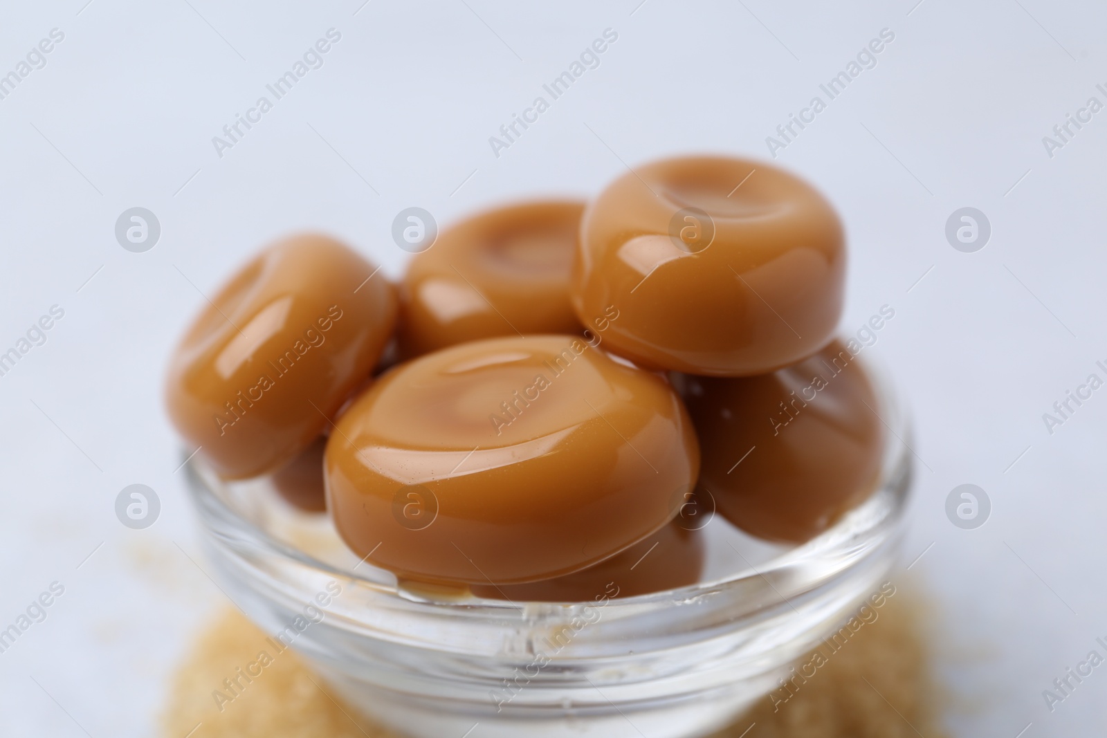 Tasty sweet caramel candies on white table, closeup Photo of Tasty sweet caramel candies on white table, closeup