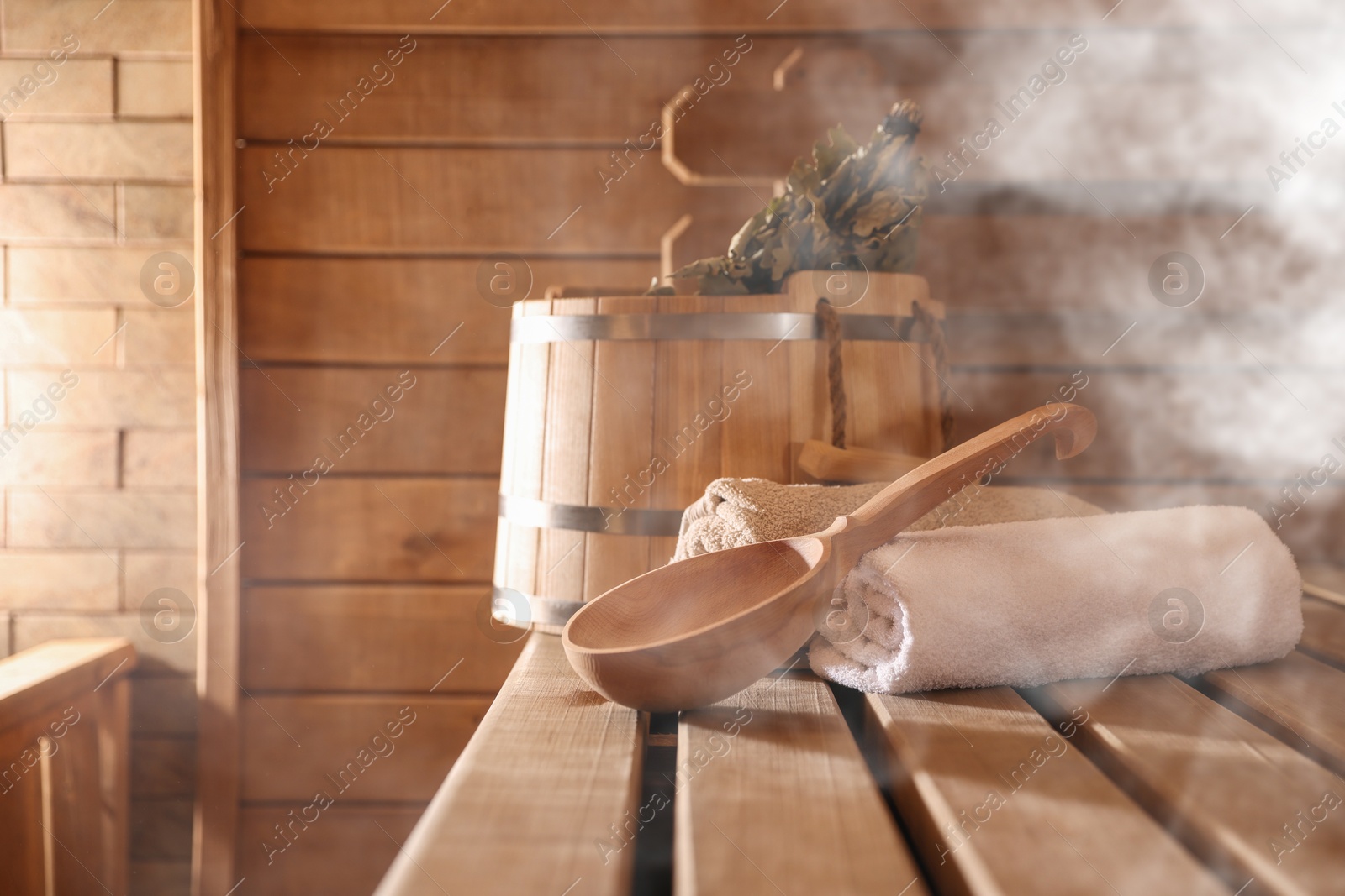 Different sauna supplies on wooden bench in steam Image of Different sauna supplies on wooden bench in steam