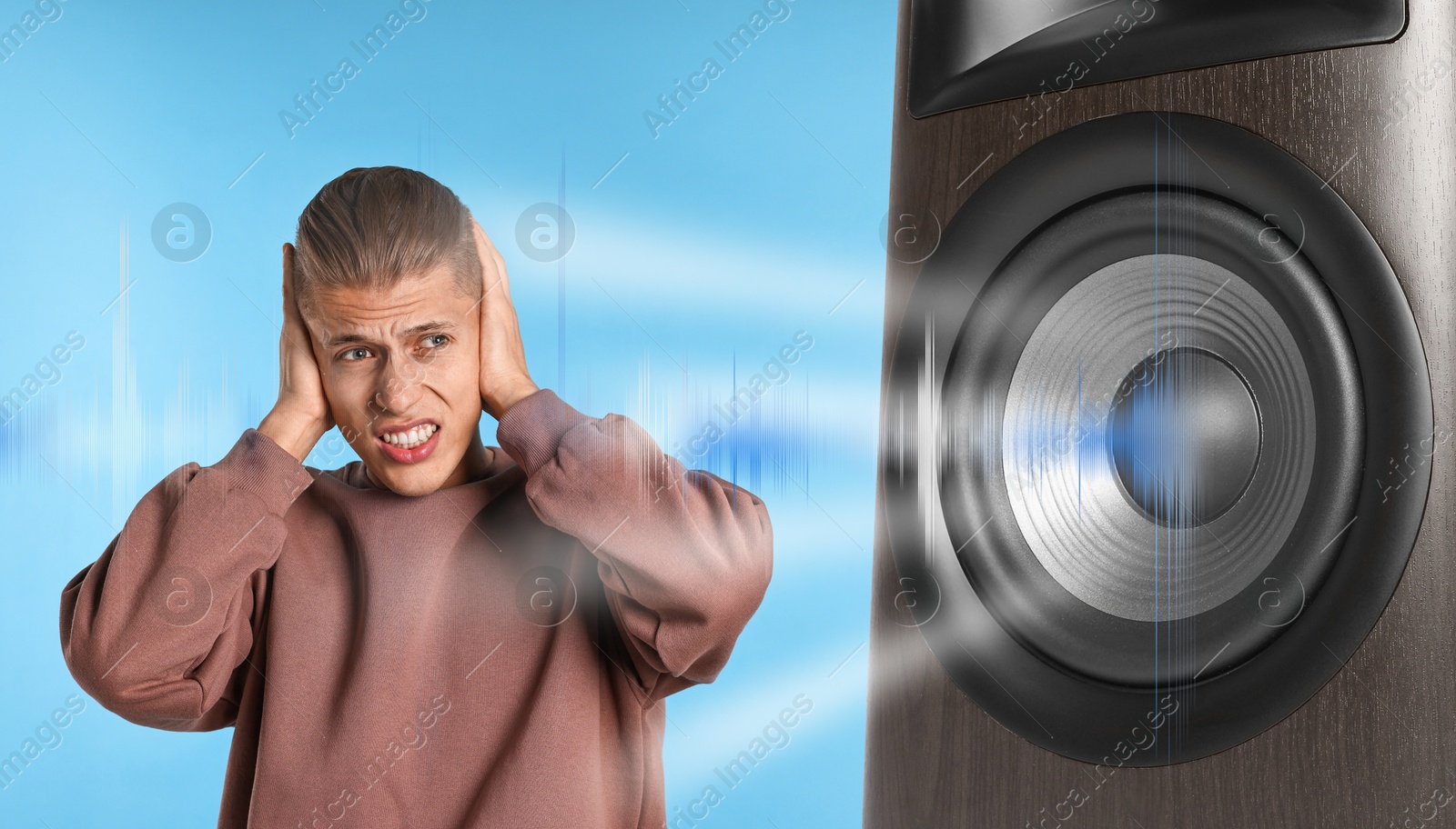 Annoyed man covering his ears from loud sound of audio speaker on light blue background Image of Annoyed man covering his ears from loud sound of audio speaker on light blue background