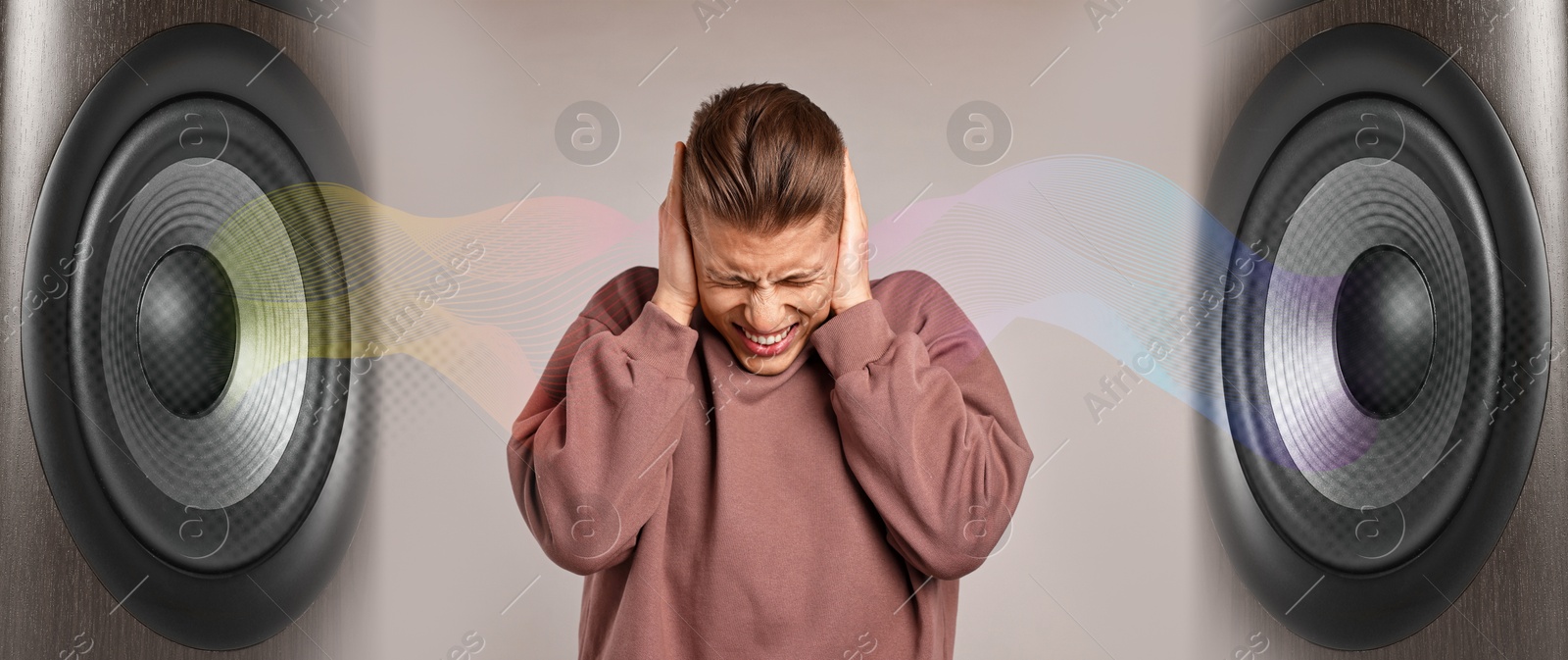 Annoyed man covering his ears from loud sound of speakers on beige grey background. Audio waves Image of Annoyed man covering his ears from loud sound of speakers on beige grey background. Audio waves