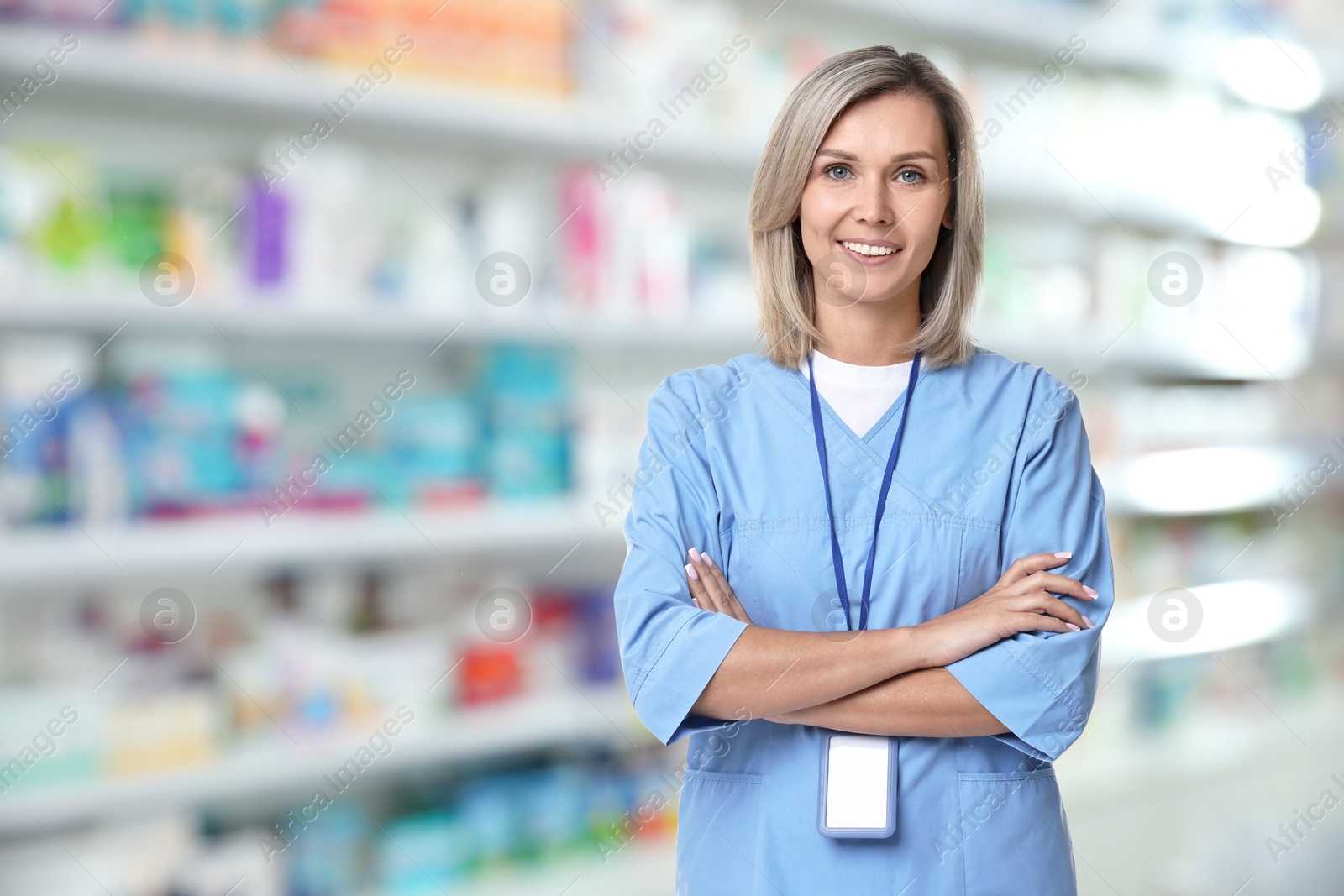 Smiling pharmacist in uniform at drugstore, space for text Image of Smiling pharmacist in uniform at drugstore, space for text