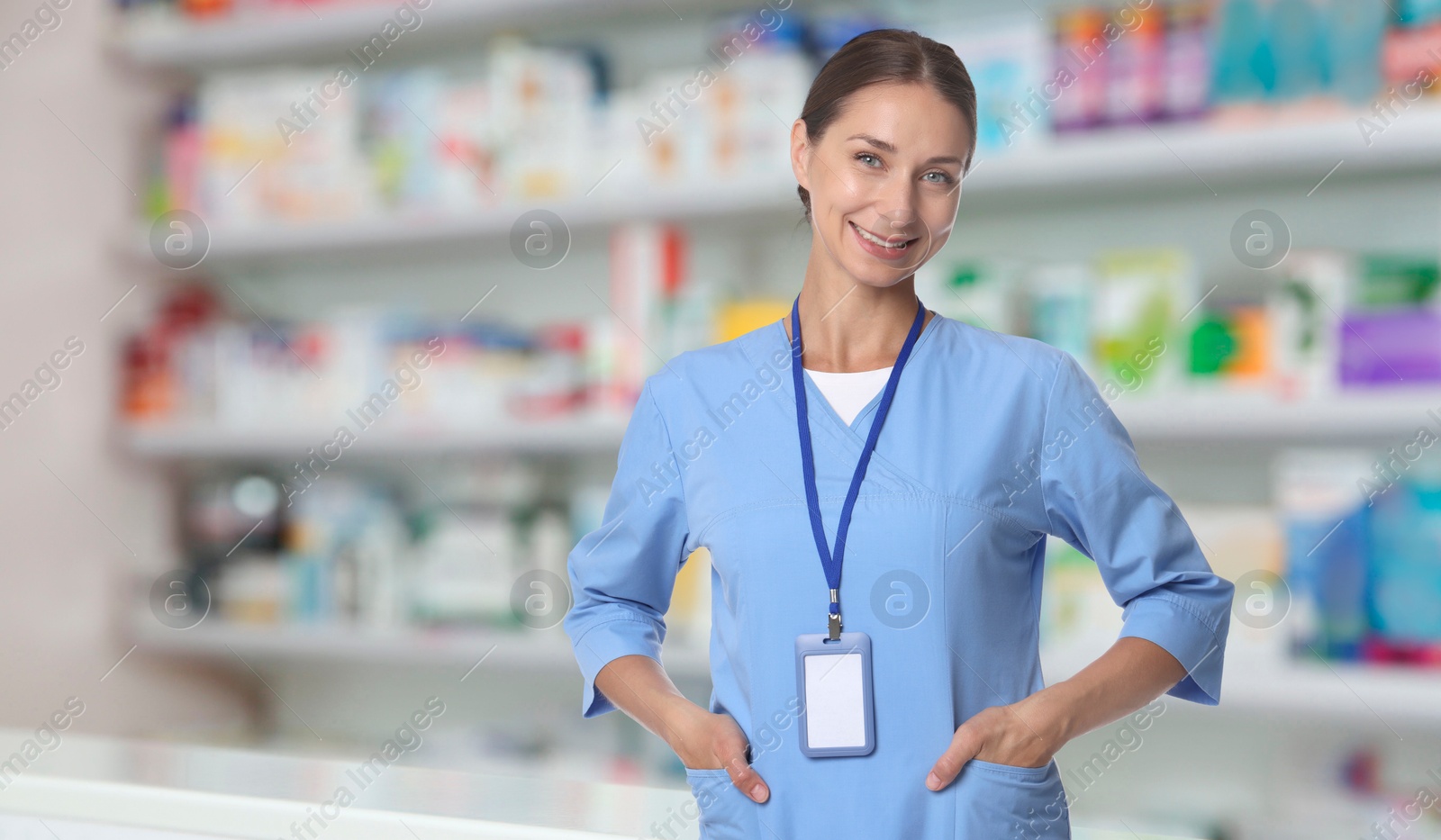 Smiling pharmacist in uniform at drugstore. Banner design Image of Smiling pharmacist in uniform at drugstore. Banner design