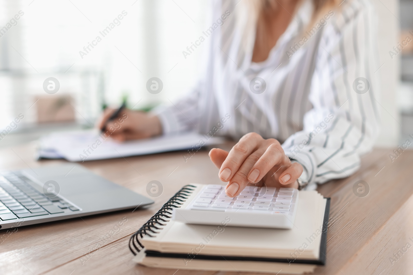 Professional banker working at desk in office, closeup Photo of Professional banker working at desk in office, closeup